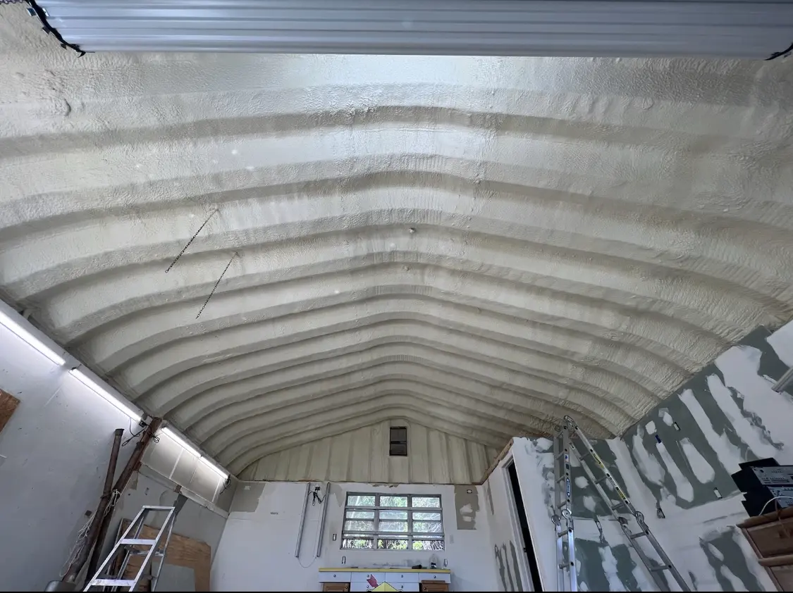Spray polyurethane foam applied to the underside of a metal roof deck in Peters